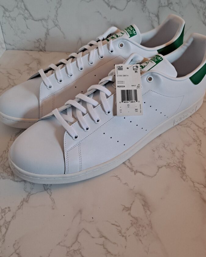 White leather sneakers with green heel accents