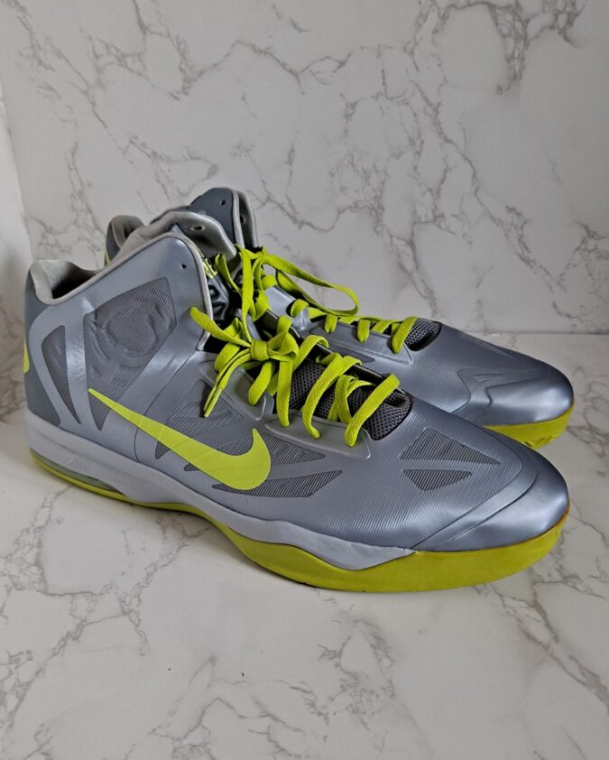 Pair of silver and neon yellow Nike sneakers