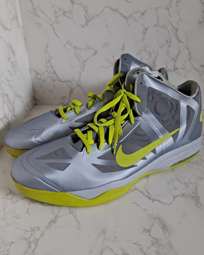 Silver Nike basketball shoes with neon laces