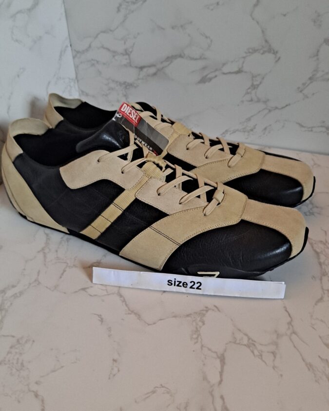 Pair of beige and black sneakers size 22